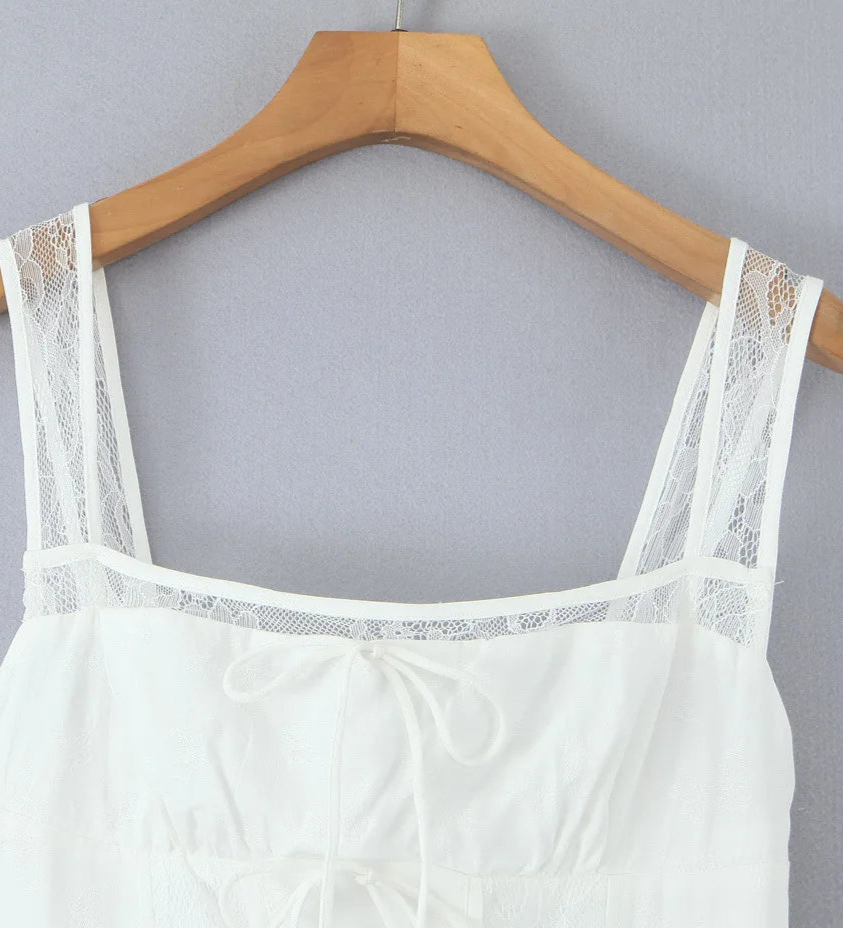 White lace-trimmed top on a wooden hanger