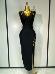 Black dress with gold accents on a mannequin against a white background