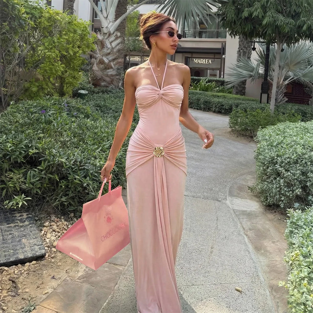 Model wearing a pink ruched bandeau swimsuit and maxi skirt outdoors