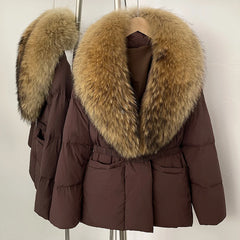 Brown winter coat with fur collar on a hanger against a white background