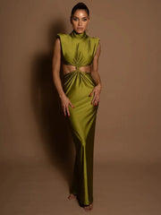 Woman wearing a green evening gown against a brown background