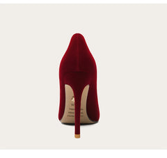 Red high-heeled shoe on a light gray background