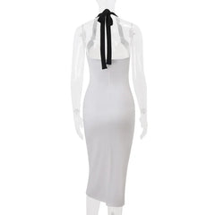 White dress with sheer sleeves and a black bow