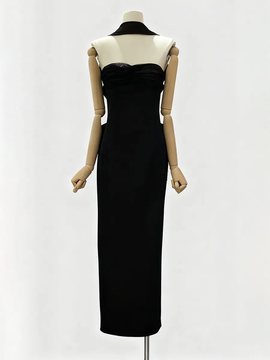 Black evening gown on a mannequin against a white background