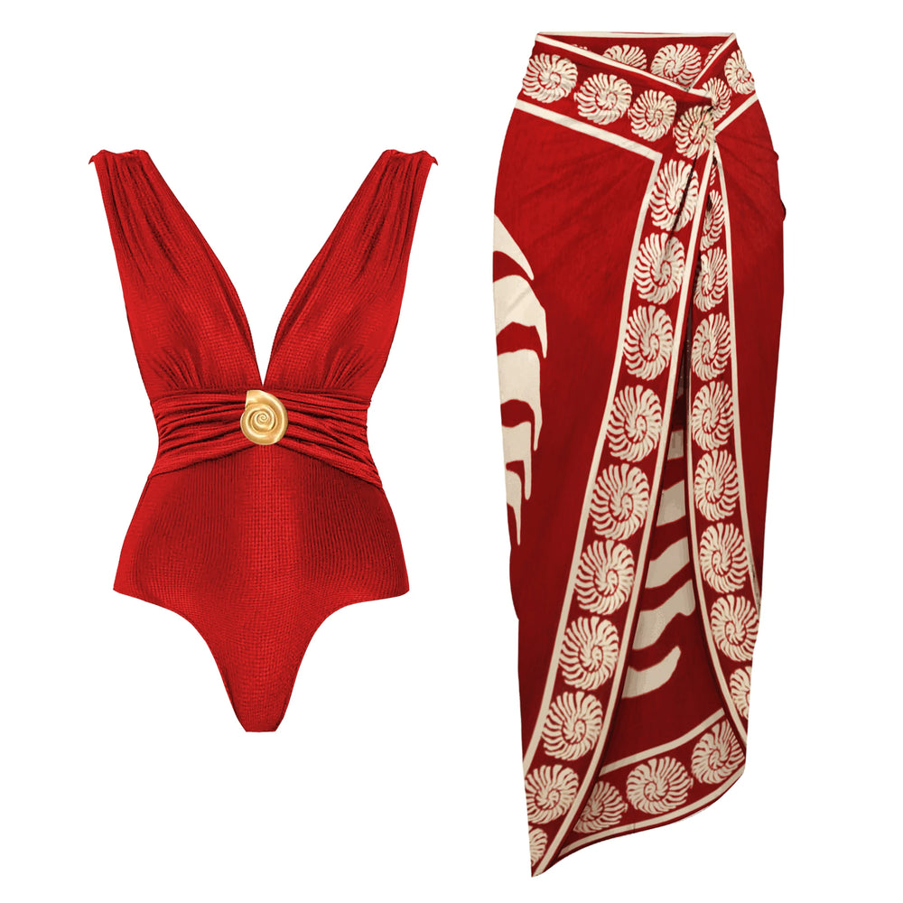 Red textured one-piece swimsuit with gold-tone embellishment and a matching red wrap skirt with a seashell-inspired print.