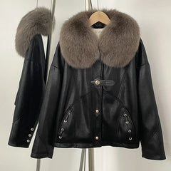 Black leather jacket with fur collar on a hanger against a neutral background