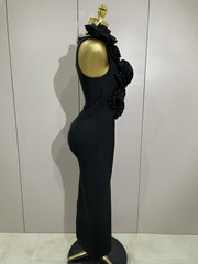 Black evening gown on a mannequin with a gold head against a white wall.