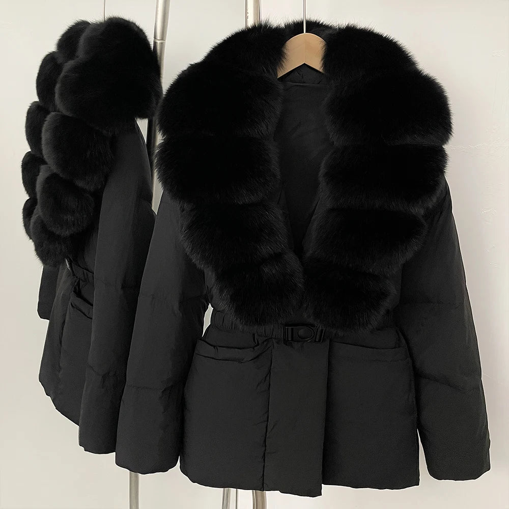 Black puffer jacket with large fur collar on a hanger against a white background