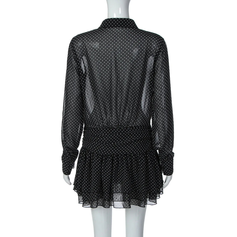 Black polka dot dress on a mannequin against a white background