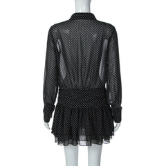 Black polka dot dress on a mannequin against a white background