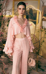 Pastel ruffled cape V-neck crop top with embellished flare trousers, close-up