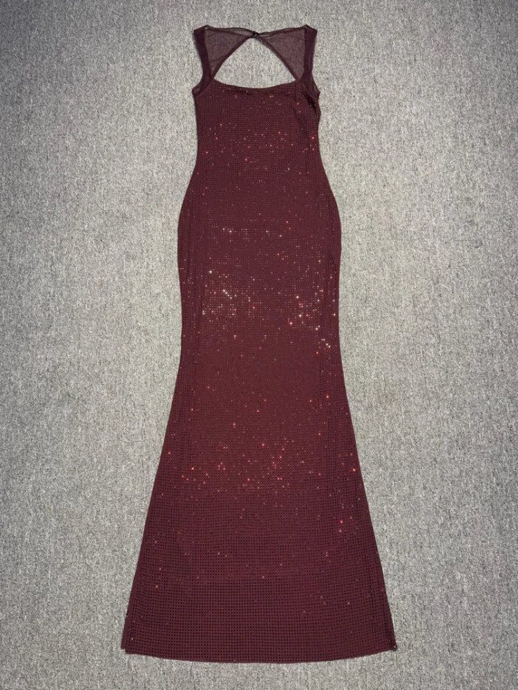 Maroon evening gown with cut-out back on a gray surface