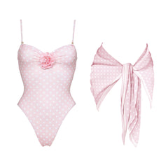 Pink polka dot one-piece swimsuit with floral accent and matching scarf.