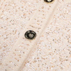 Close-up of a textured beige fabric with a button