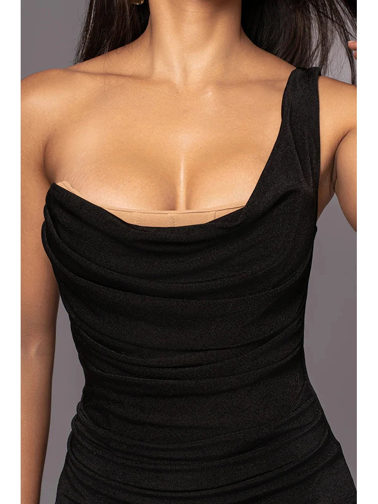 Black sleeveless top worn by a person on a gray background