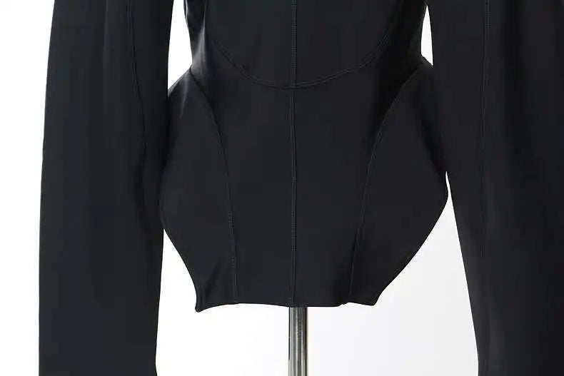 Black long-sleeve top on a mannequin against a white background