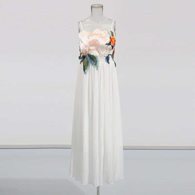 White dress with floral embroidery on a mannequin against a white background