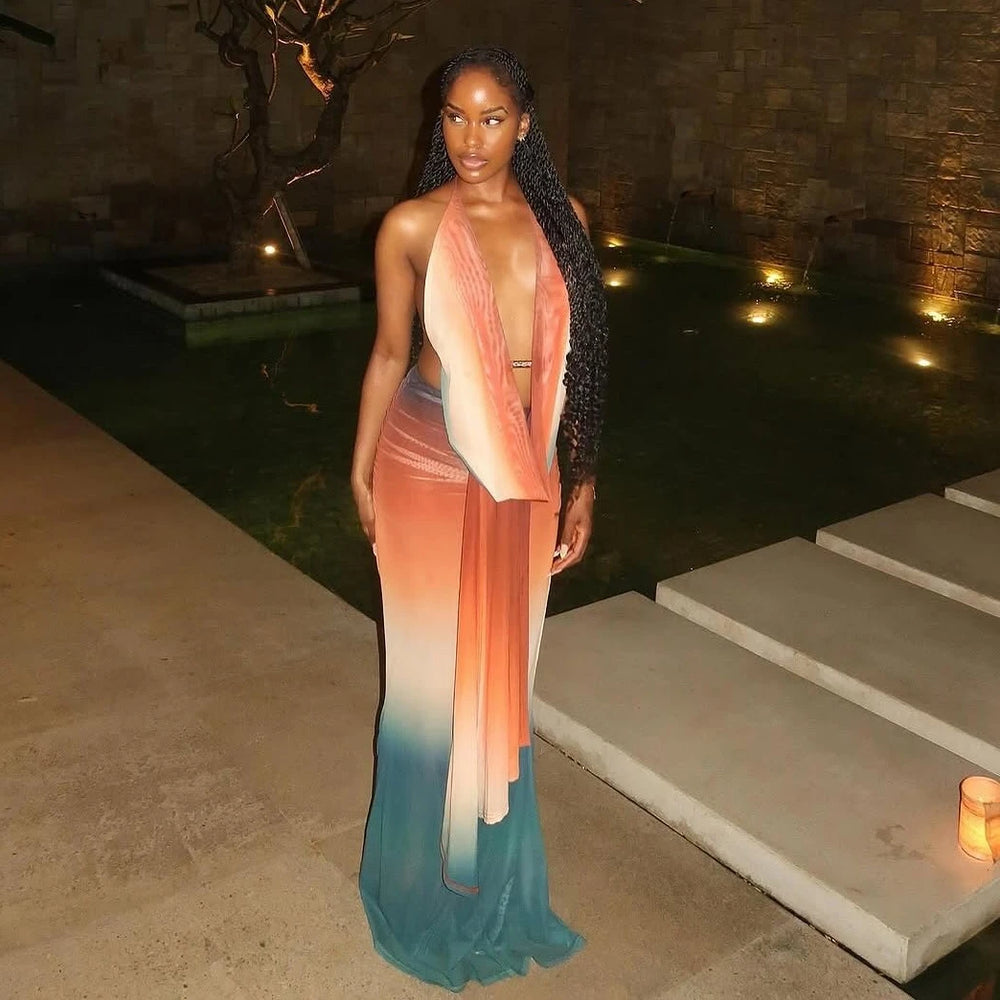 Woman in a gradient dress standing outdoors near a pool