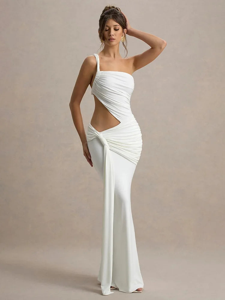 Woman wearing a white evening gown with cut-out design on a beige background