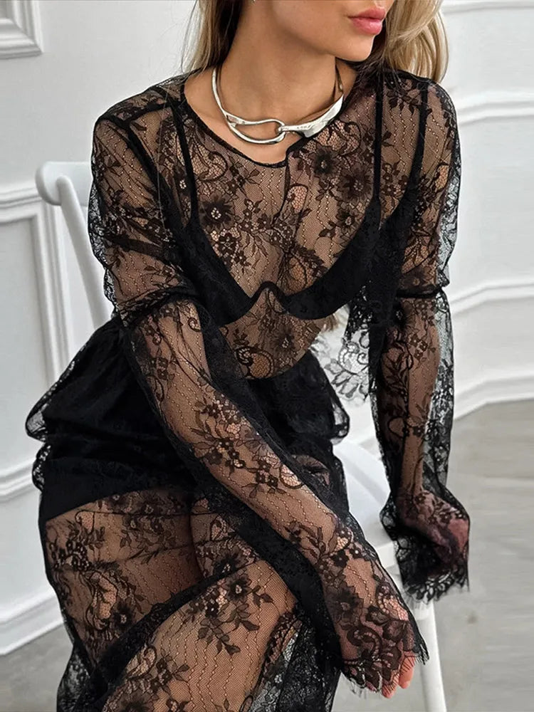 Black lace dress worn by a person in an indoor setting