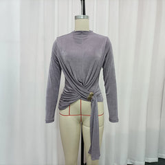 Draped mock neck long sleeve ruched top with buckle accent on mannequin