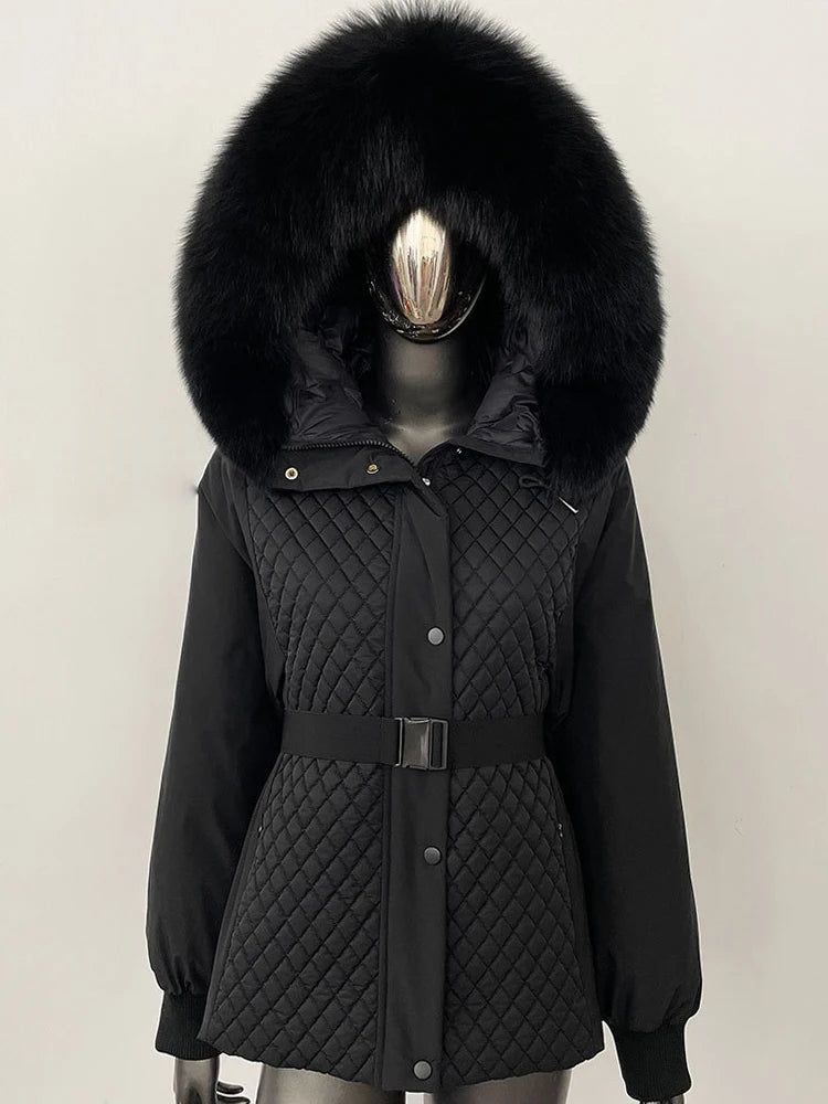 Black quilted jacket with a large fur hood on a mannequin against a plain background