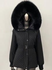 Black quilted jacket with a large fur hood on a mannequin against a plain background
