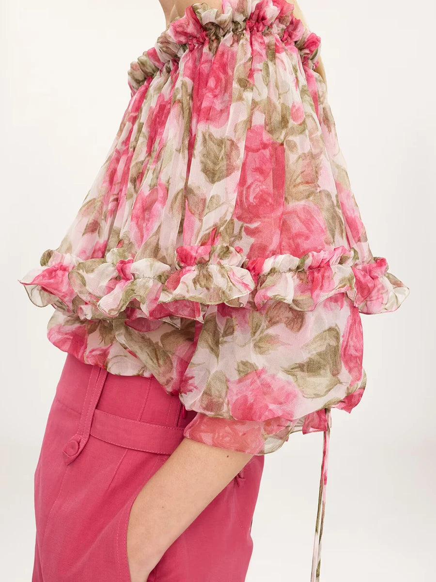 Detail of the sleeve and hem on a ruffled off-shoulder blouse.