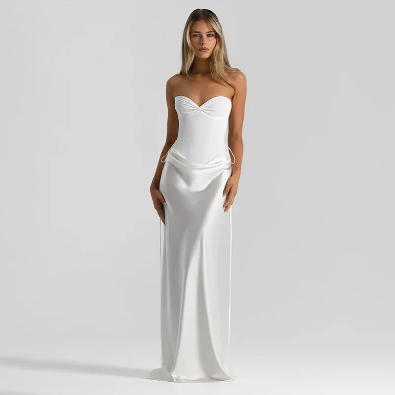 Woman wearing a white strapless gown on a plain background