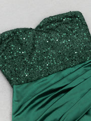 Green sequin top and satin skirt on a light gray background