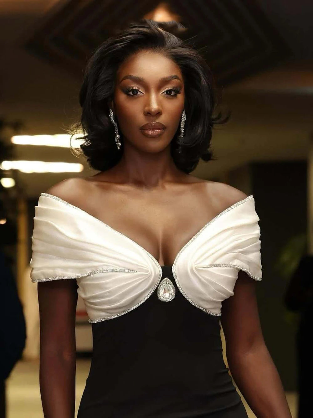 Woman wearing a black and white dress with a blurred background