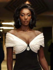 Woman wearing a black and white dress with a blurred background