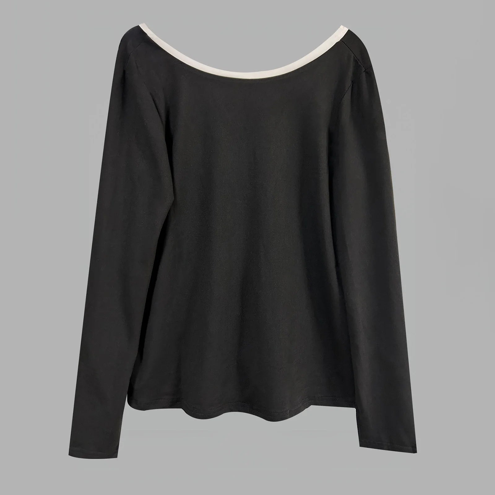 Black long-sleeve top with white neckline on a gray background