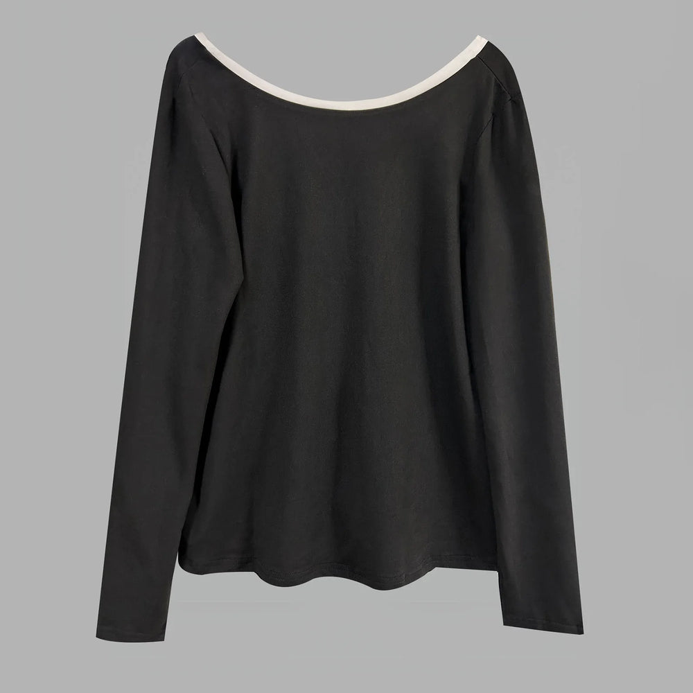 Black long-sleeve top with white neckline on a gray background
