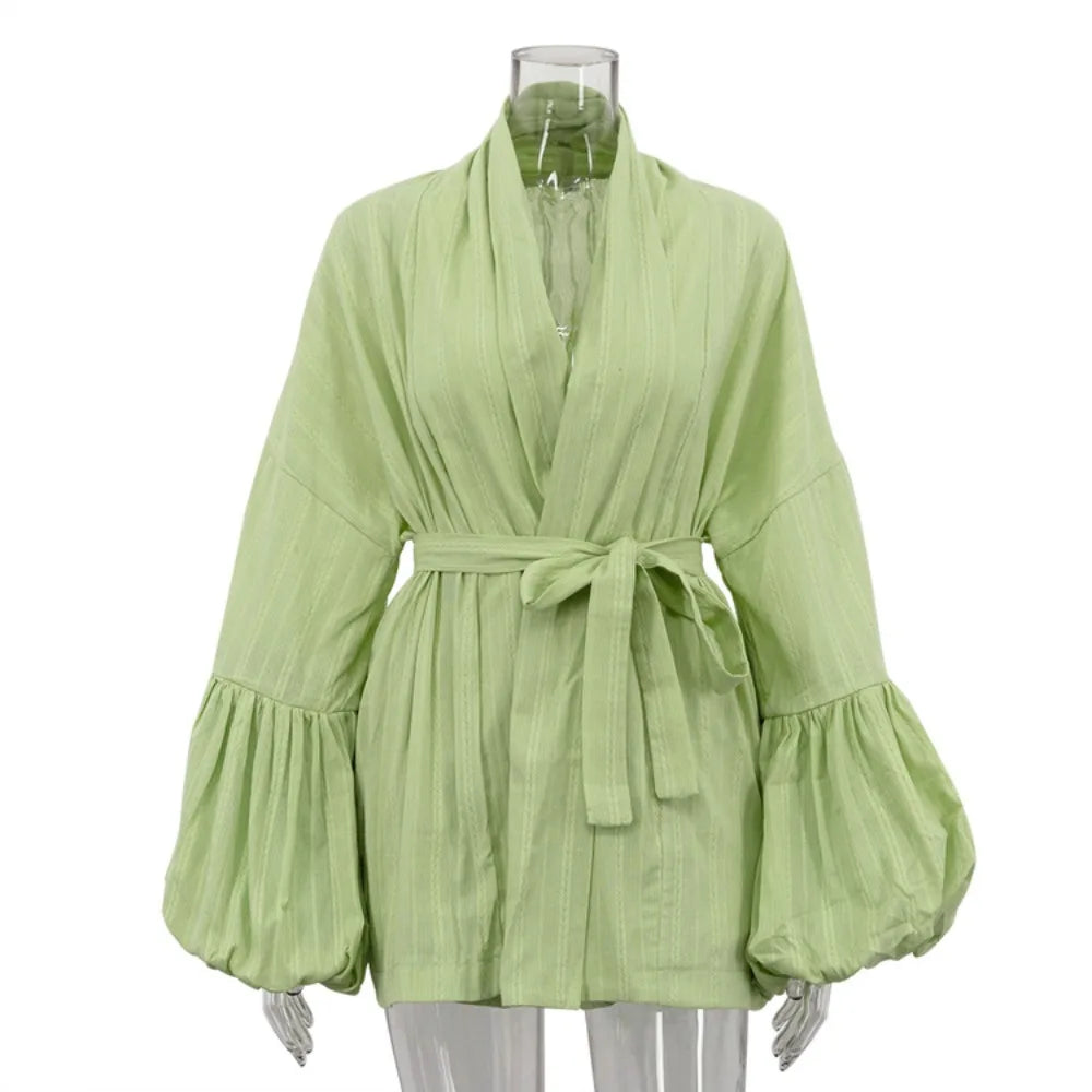 Light green dress with wide sleeves on a mannequin against a white background