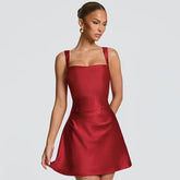 Red dress worn by a model on a light gray background