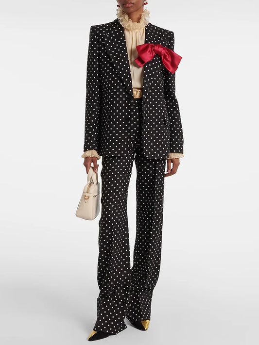 Polka dot print blazer and wide-leg pants set with a red bow detail worn by a model.