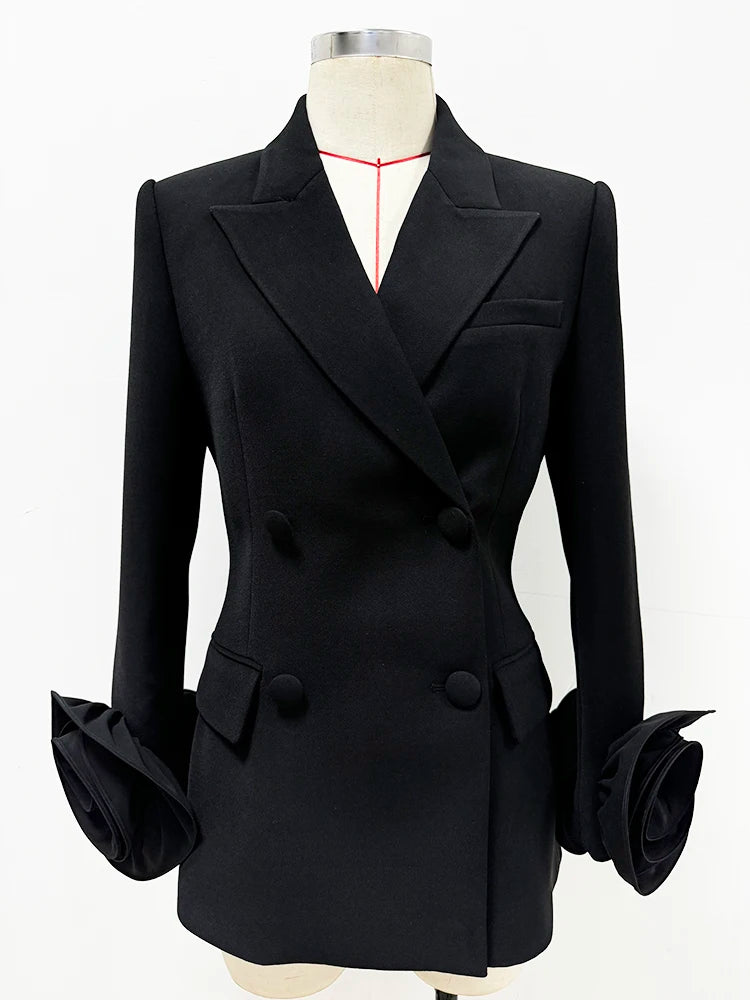 Sculpted double-breasted black blazer with dramatic floral cuffs shown on a mannequin.