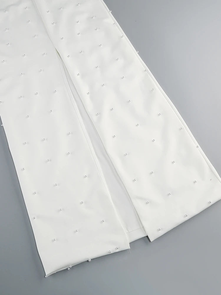 Two white mattress toppers with small gray dots on a gray background