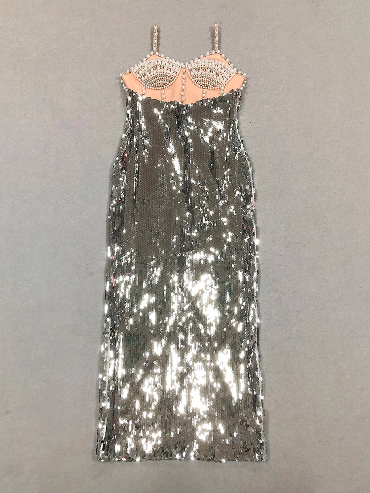 Silver sequin dress with a beige bralette on a gray background