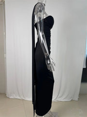 Black evening gown on a transparent mannequin against a white curtain background
