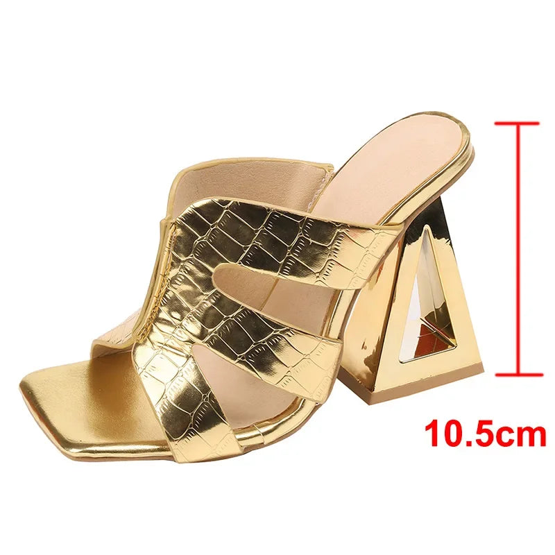 Gold high-heeled shoe with measurements on a white background