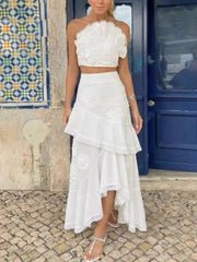 White floral lace one-shoulder crop top with an asymmetric ruffle midi skirt.