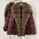 Maroon puffer jacket with fur trim on a hanger