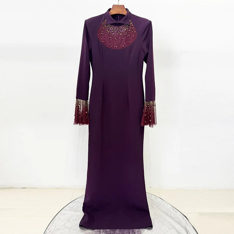 Purple maxi dress with beaded neckline and flare sleeves displayed on a hanger