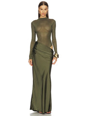 Woman wearing a green evening gown with a white background