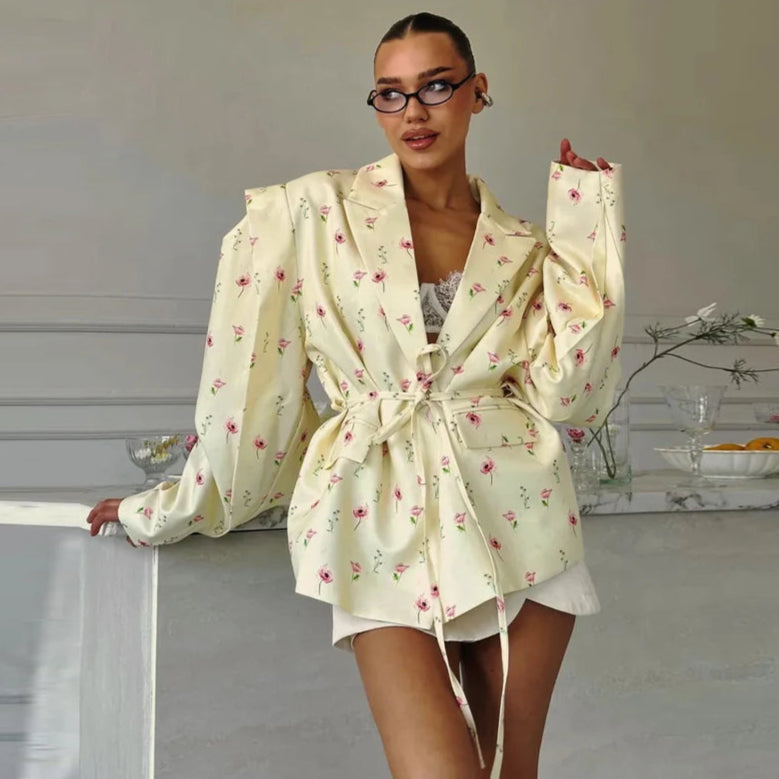 Woman wearing a floral robe in a room with a neutral background