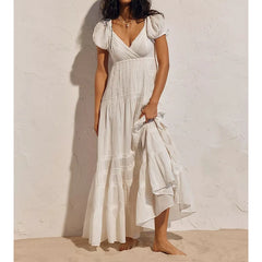 White puff sleeve V-neck maxi dress with lace details.