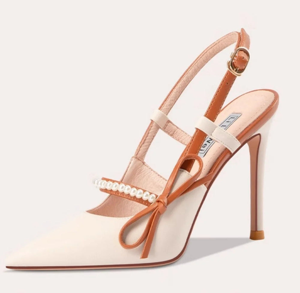 High-heeled shoe with tan strap and clear heel on a white background