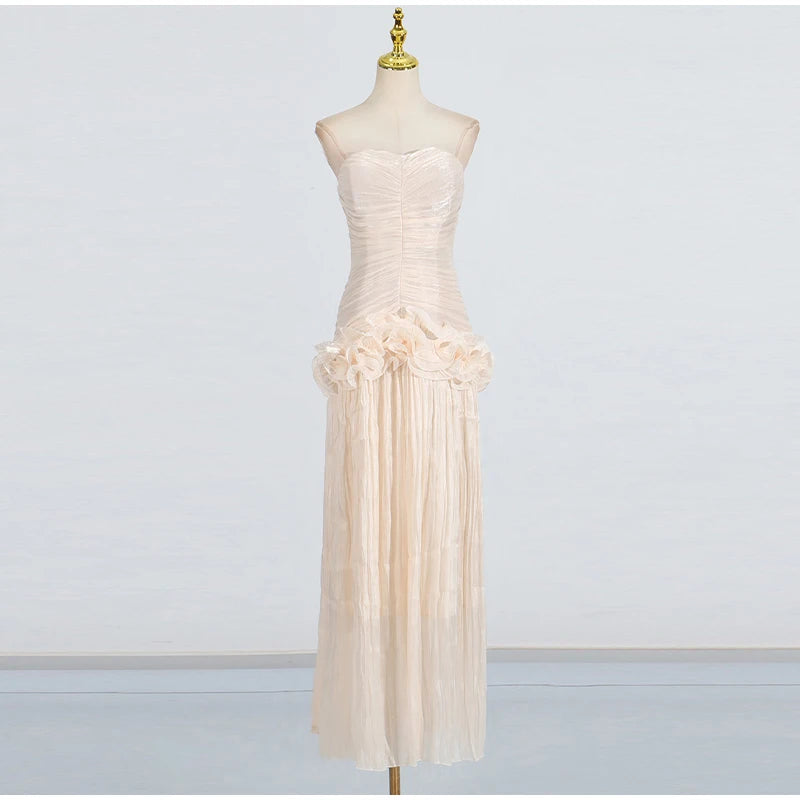 Beige strapless dress on a mannequin against a plain background